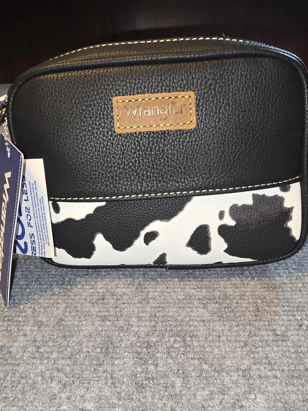 Wrangler black and white cow print crossbody bag.